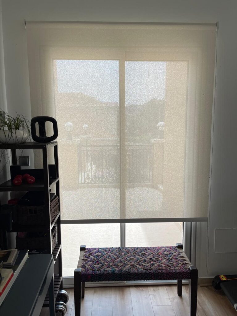 Sunscreen roller blinds Dubai installed in modern office with sunlight control